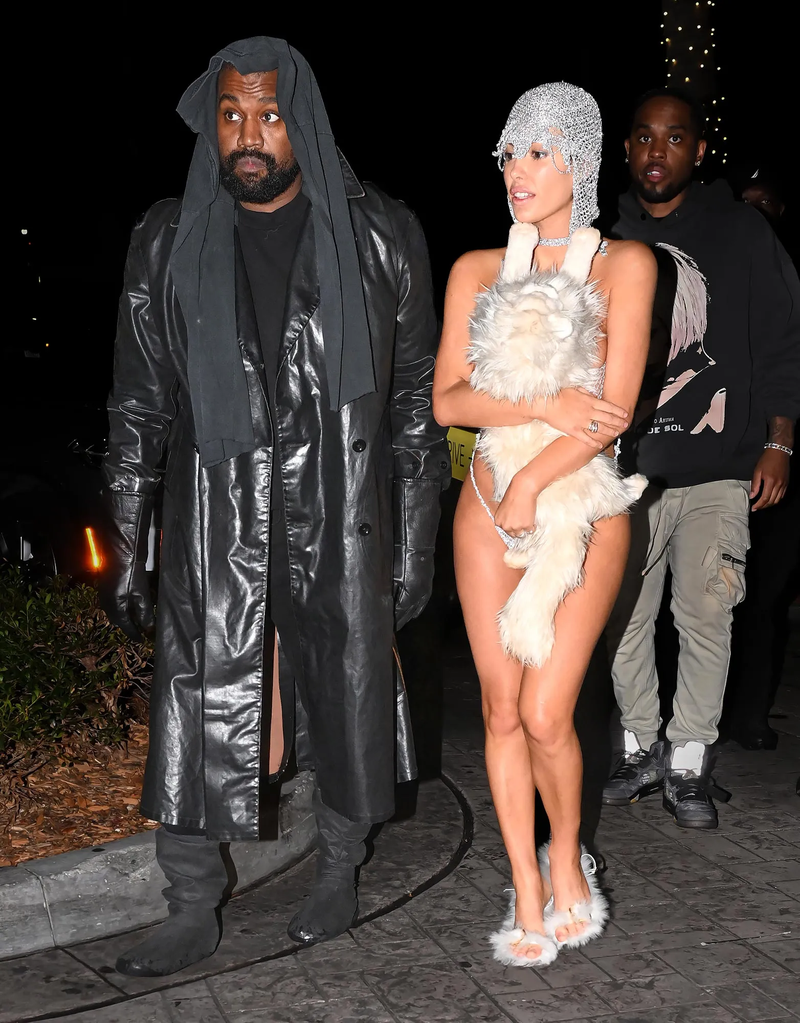 Bianca-Censori-Covers-Up-Silver-String-Set-With-Stuffed-Cat-While-Out-With-Husband-Kanye-West-1